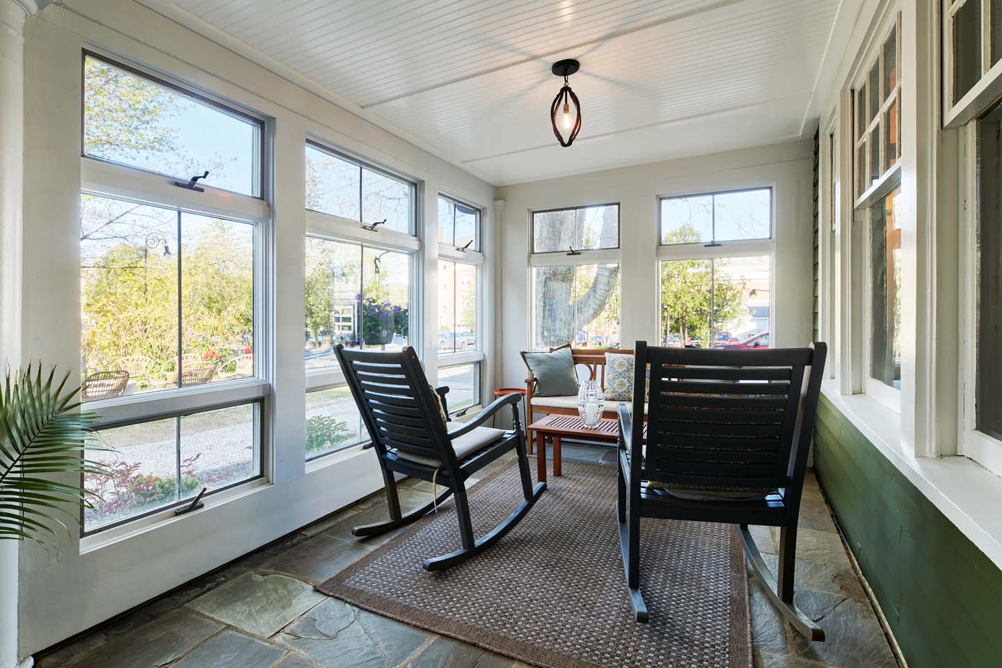 Glassed-in front porch with rocking chairs