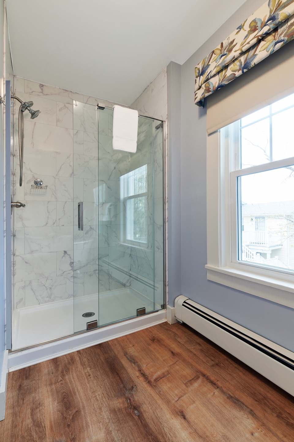 Marble walk-in shower with floral valance