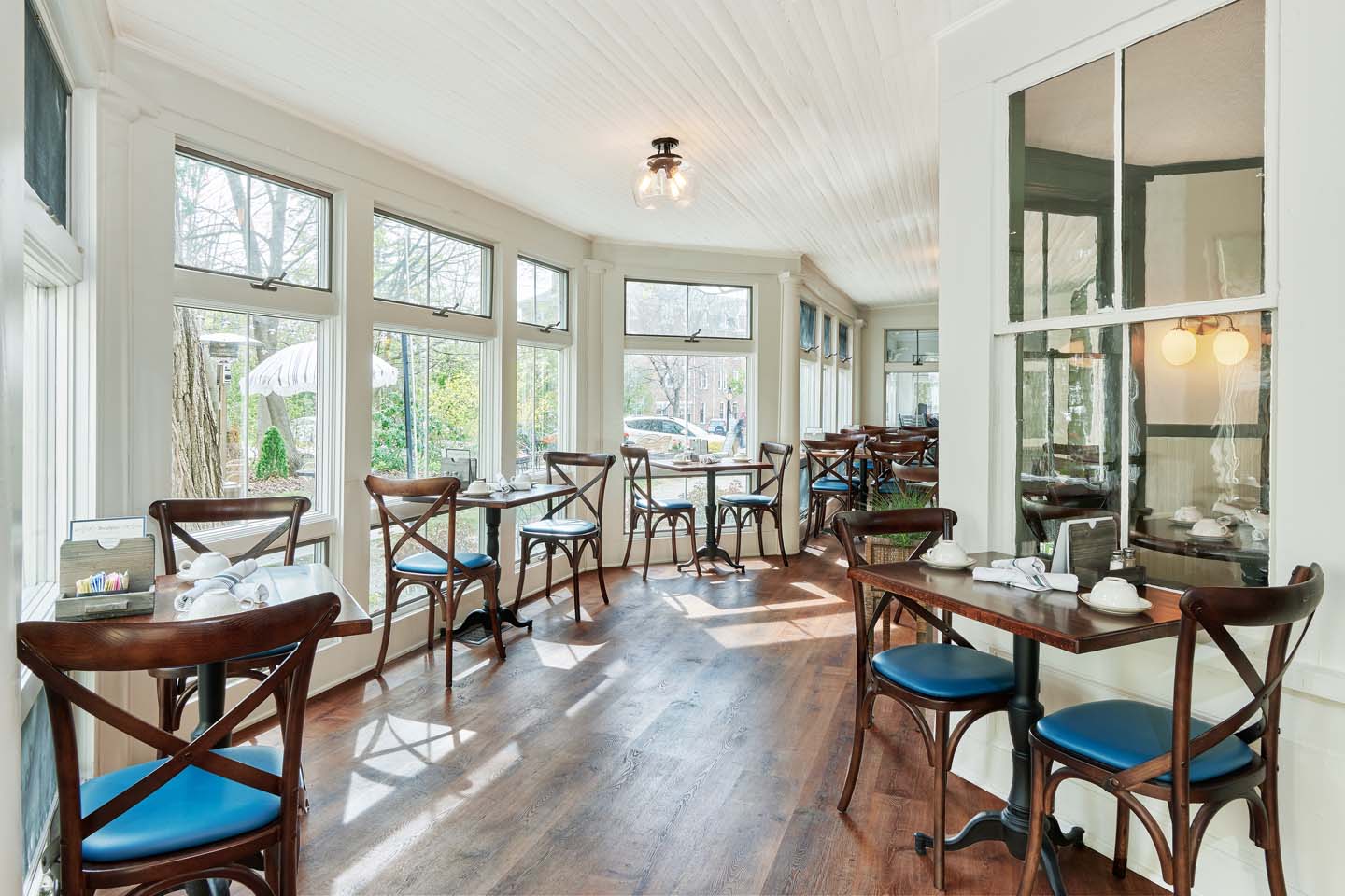 Sunlit breakfast room with bentwood chairs