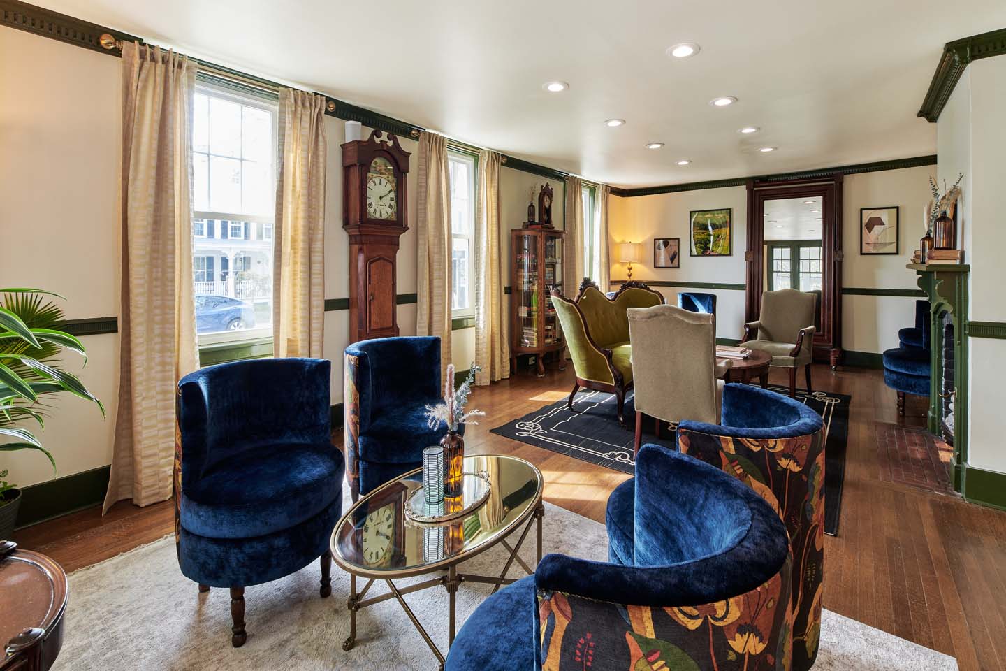 Parlor with blue velvet chairs and grandfather clock