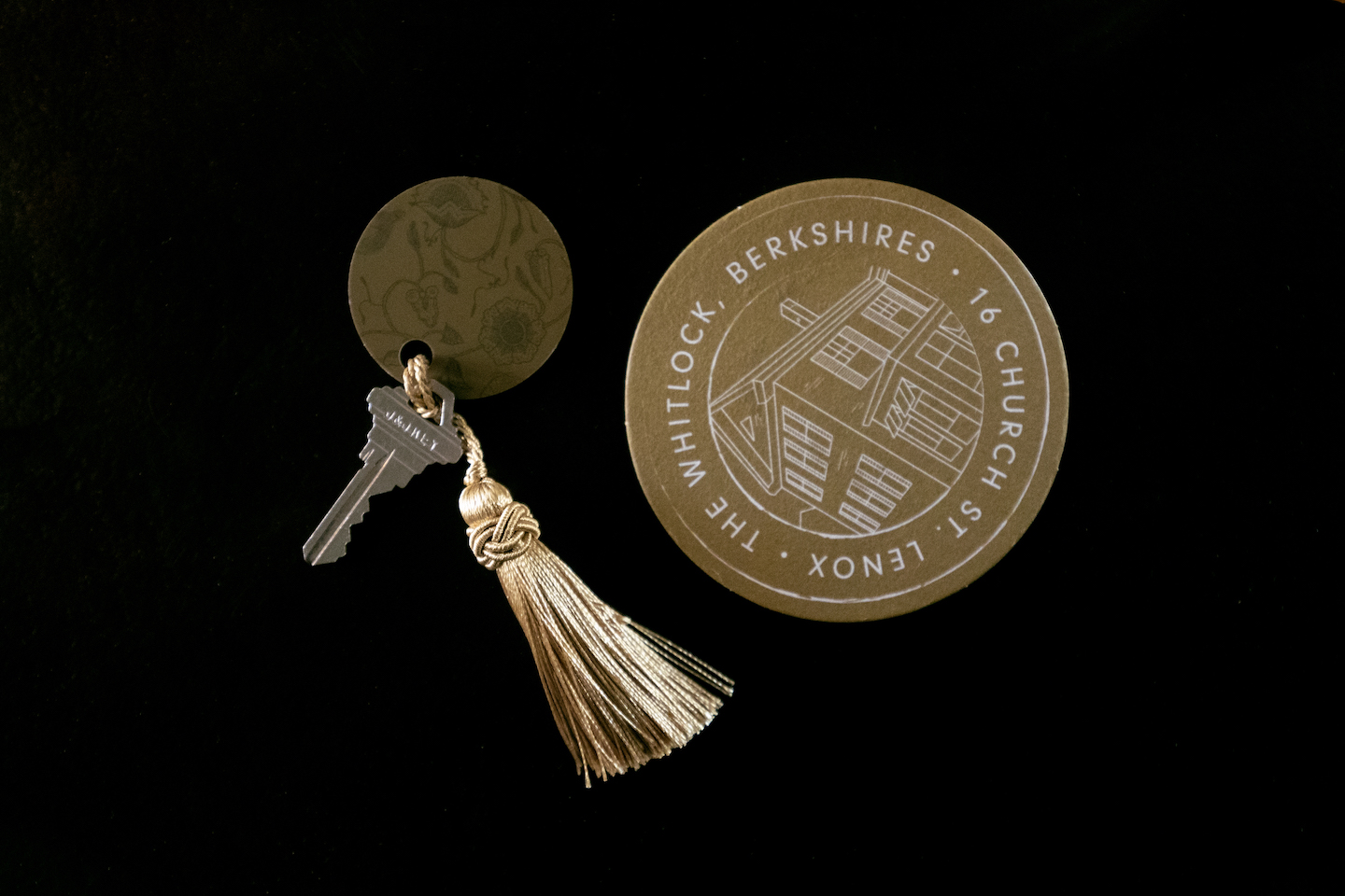 Room key with gold tassel and printed key tag