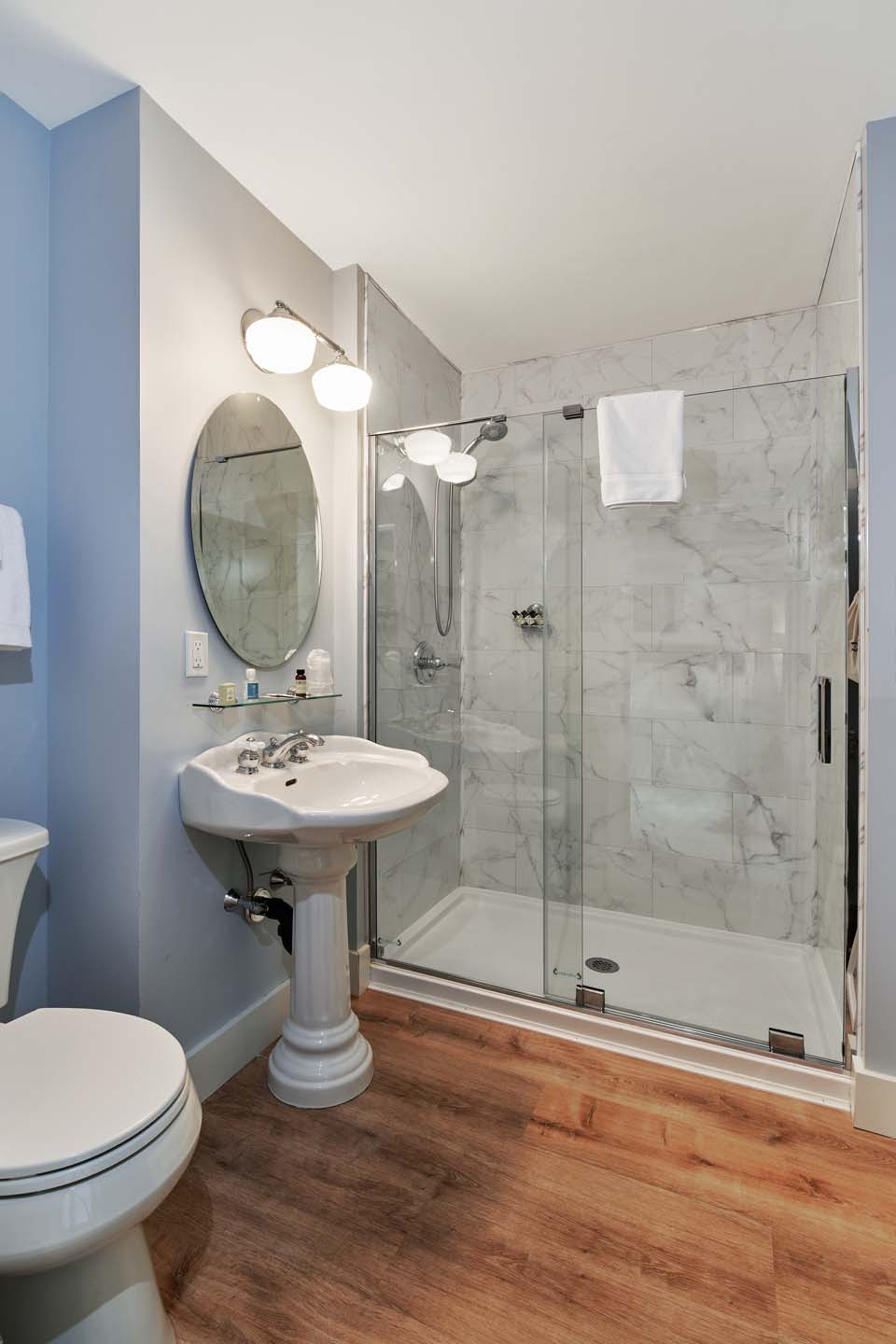 Bathroom with pedestal sink and marble walk-in shower
