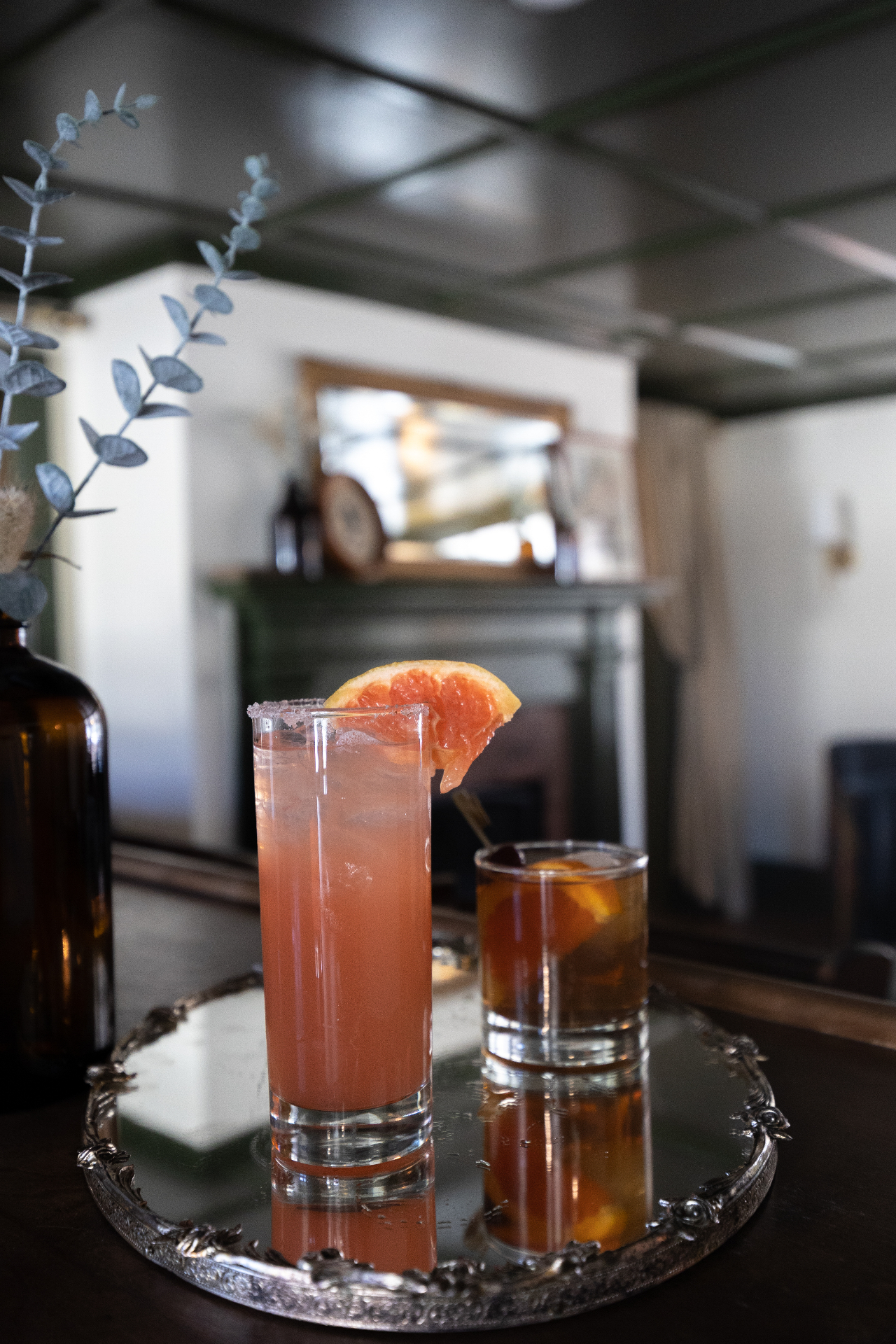 Grapefruit cocktail and old fashioned on a silver tray