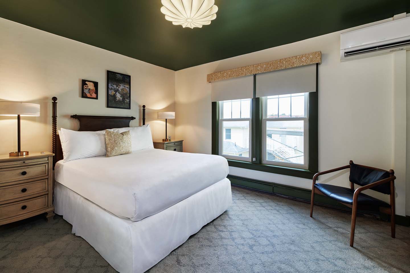 Queen guest room with green ceiling and tall window