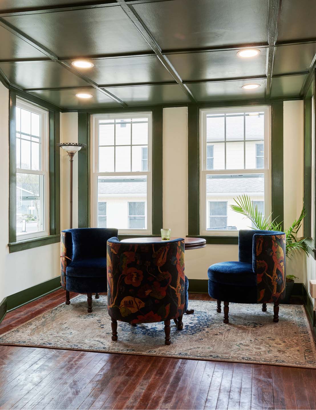 Window nook with velvet armchairs and floral upholstery