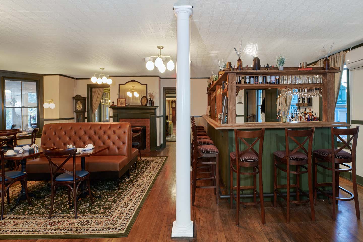 Bar and adjoining dining room with booth seating